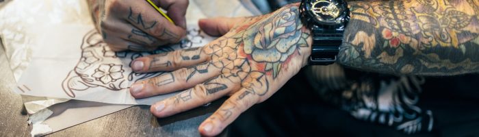 Tattoo artist designing motifs