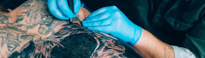 tattoo master makes a tattoo. Closeup. Selective focus